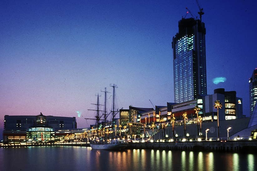 A snapshot of a website displaying a towering building by a waterfront.